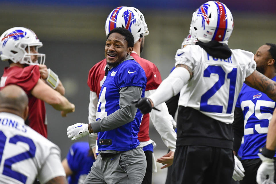 Buffalo Bills wide receiver Stefon Diggs, center, laughs with safety Jordan Poyer (21) during an NFL football practice in Orchard Park, N.Y., Thursday, Jan. 12, 2023. (AP Photo/Adrian Kraus)