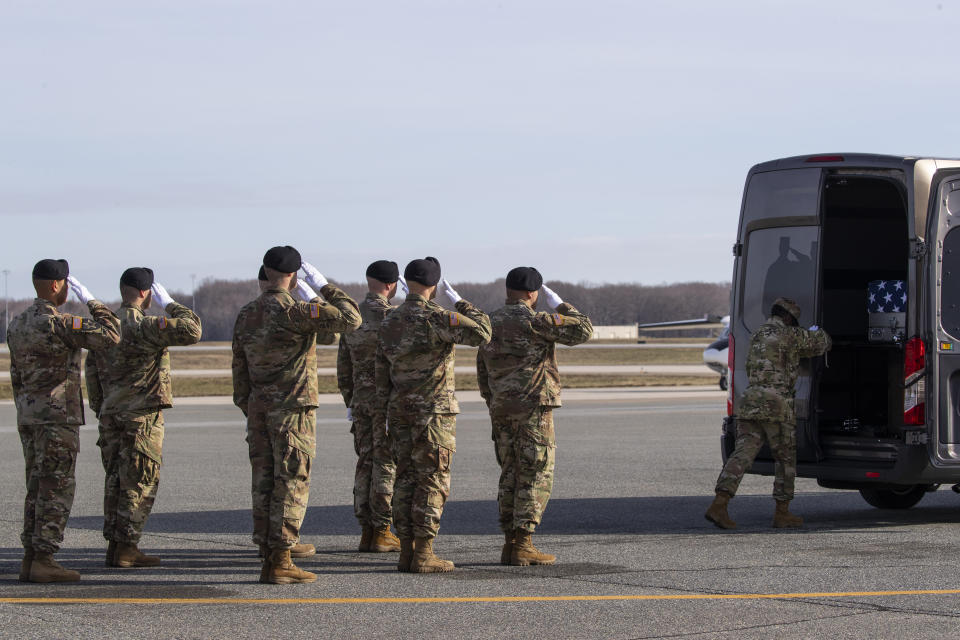 An Army carry team slaues a transfer case containing the remains of U.S. Army Sgt. 1st Class Michael Goble, as U.S. Air Force Tech. Sgt. Shaquita Darby closes the door, Wednesday, Dec. 25, 2019, at Dover Air Force Base, Del. According to the Department of Defense, Goble, of Washington Township, N.J., assigned to the 7th Special Forces Group, died while supporting Operation Freedom's Sentinel. (AP Photo/Alex Brandon)