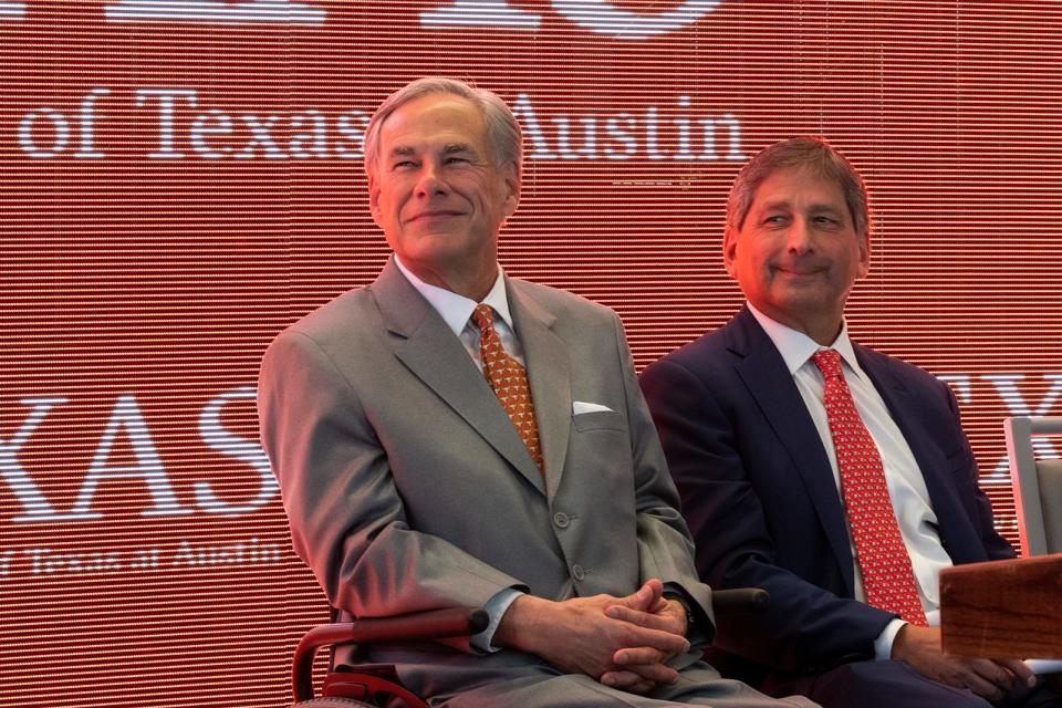 Gov. Greg Abbott and UT System Board of Regents Chairman Kevin P. Eltife smile as plans to build a hospital and cancer center are announced.