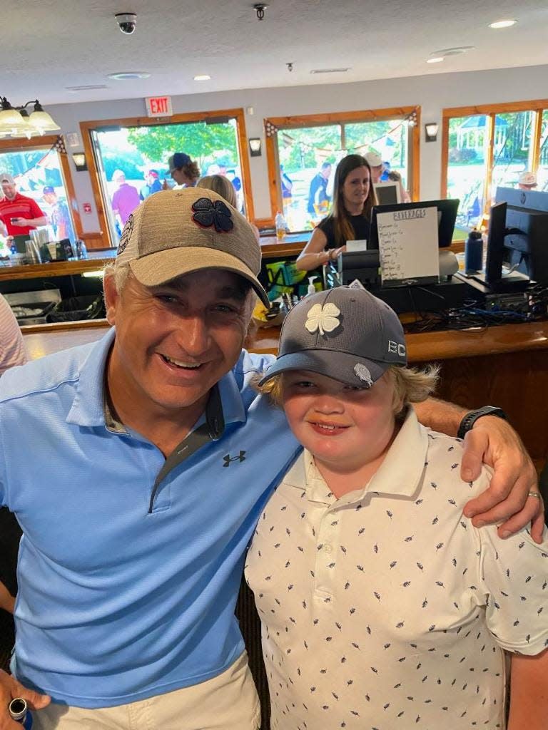 Brian Kelliher and Hanover Middle School fifth grader Cole Mahoney after sinking consecutive holes-in-ones at Pembroke Country Club on Friday, June 17, 2022.