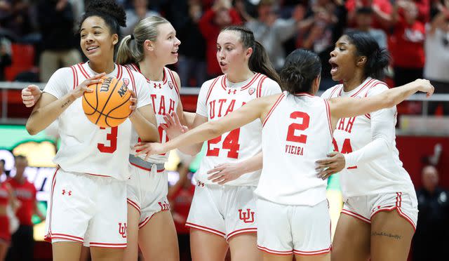 <p>Chris Gardner/Getty</p> Lani White #3, Reese Ross #20, Kennady McQueen #24, Ines Vieira #2, and Dasia Young #34 of the Utah Utes celebrate their win over the USC Trojans