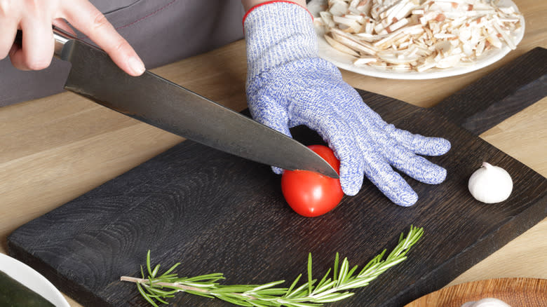 Cutting tomato hand in cut-resistant glove