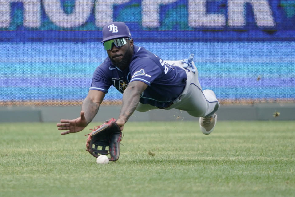 A ball hit by Kansas City Royals' Michael A. Taylor drops in front of the glove of Tampa Bay Rays left fielder Randy Arozarena for a single in the sixth inning during a baseball game, Sunday, July 24, 2022, in Kansas City, Mo. (AP Photo/Ed Zurga)