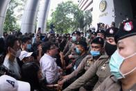 Pro-democarcy protesters stand outside the criminal court building demanding a representative be allowed inside were two leader still detained at the criminal court in Bangkok