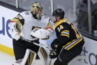Boston Bruins right wing Chris Wagner (14) tangles with Vegas Golden Knights goaltender Marc-Andre Fleury (29) during the first period of an NHL hockey game in Boston, Tuesday, Jan. 21, 2020. (AP Photo/Charles Krupa)