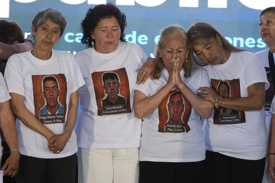 Relatives of 19 young people who were falsely presented as guerrillas killed in combat by the Colombian army during the country's internal conflict, attend an act of recognition and public apology by the state for their extrajudicial execution, in Bogota, Colombia, Tuesday, Oct. 3, 2023. (AP Photo/Fernando Vergara)