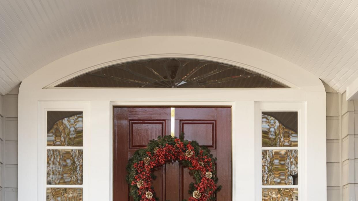 front door with wreath and poinsettias decoration