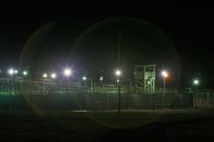 GUANTANAMO BAY, CUBA - OCTOBER 03: (IMAGE REVIEWED BY U.S. MILITARY PRIOR TO TRANSMISSION) Bright lights, guard towers and razor wire-topped fences mark the perimeter of the Camp Delta detention facility October 3, 2007 at the U.S. Naval Station at Guantanamo Bay, Cuba. About 340 enemy combatants captured since the September 11, 2001 attacks on the U.S. continue to be held on the island. (Photo by Chip Somodevilla/Getty Images)