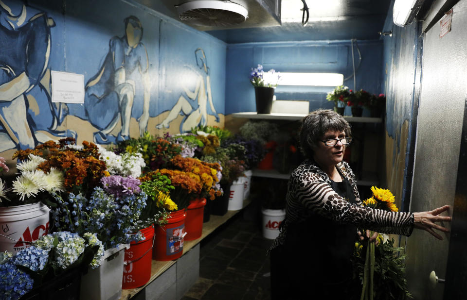 Debbie Key, 58, walks out of the cooler while working at Brenda's House of Flowers on election day in Woodstock, Ga., Tuesday, Nov. 6, 2018. "I'm apolitical and I would not think that my one vote would make a difference. I'm a little disillusioned," said Key. "I am not educated enough on policy," she adds. "And what is presented to me through commercials, TV ads, forget it. It's just not enough for me to have an opinion. I'm pretty much ambivalent. Nothing lights me up." (AP Photo/David Goldman)