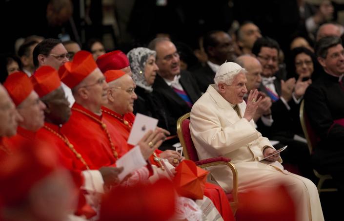 Pope Emeritus Benedict XVI waves as he attends a consistory inside the St. Peter's Basilica at the Vatican, Saturday, Feb.22, 2014. Benedict XVI has joined Pope Francis in a ceremony creating the cardinals who will elect their successor in an unprecedented blending of papacies past, present and future. (AP Photo/Alessandra Tarantino)