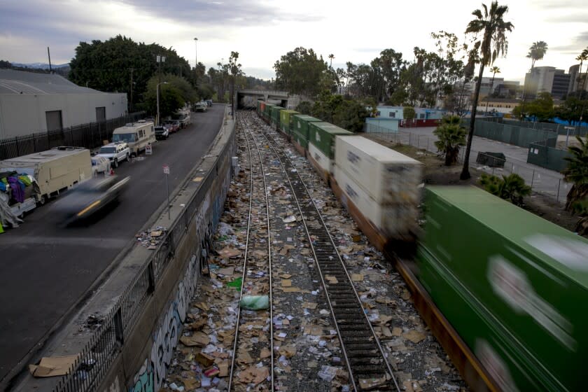 Los Angeles, CA - January 15: A freight train navigates the tracks in downtown Los Angeles that has been littered with thousands of shredded boxes, packages stolen from cargo containers that stop in the area to unload in the vicinity of Mission Blvd. on Saturday, Jan. 15, 2022 in Los Angeles, CA. (Irfan Khan / Irfan Khan)