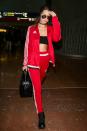 <p>Bella a opté pour un survêtement Adidas porté avec une paire de boots noires, des lunettes de soleil et un sac à main. (Photo : Getty) </p>