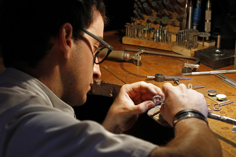 A jewel maker at work at the Chaumet jewelry house in Paris, in this photo dated Friday June 14, 2013, as part of the Les Journees Particulieres, event organised for two days by LVMH group. More than forty LVMH group locations throughout Europe are opening their doors and inviting the public to discover the savoir-faire of the luxury fashion industry group, for a two day open-door event. (AP Photo/Remy de la Mauviniere)