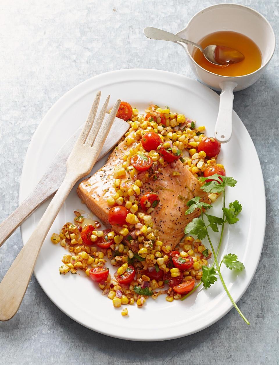 Bake the tomatoes and corn in this recipe alongside the salmon for convenience and ease.