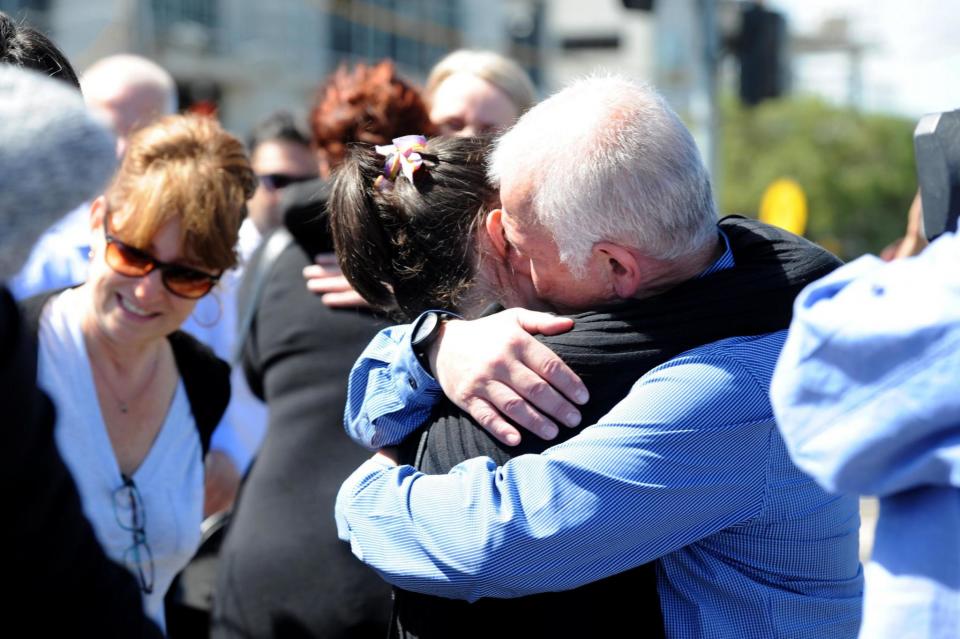 'Desperately sad': Employees at the Direct Factory Outlet in Melbourne comfort each other (EPA)