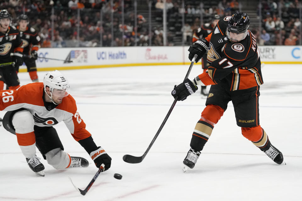 Anaheim Ducks left wing Alex Killorn (17) shoots against Philadelphia Flyers defenseman Sean Walker (26) during the third period of an NHL hockey game in Anaheim, Calif., Friday, Nov. 10, 2023. (AP Photo/Ashley Landis)