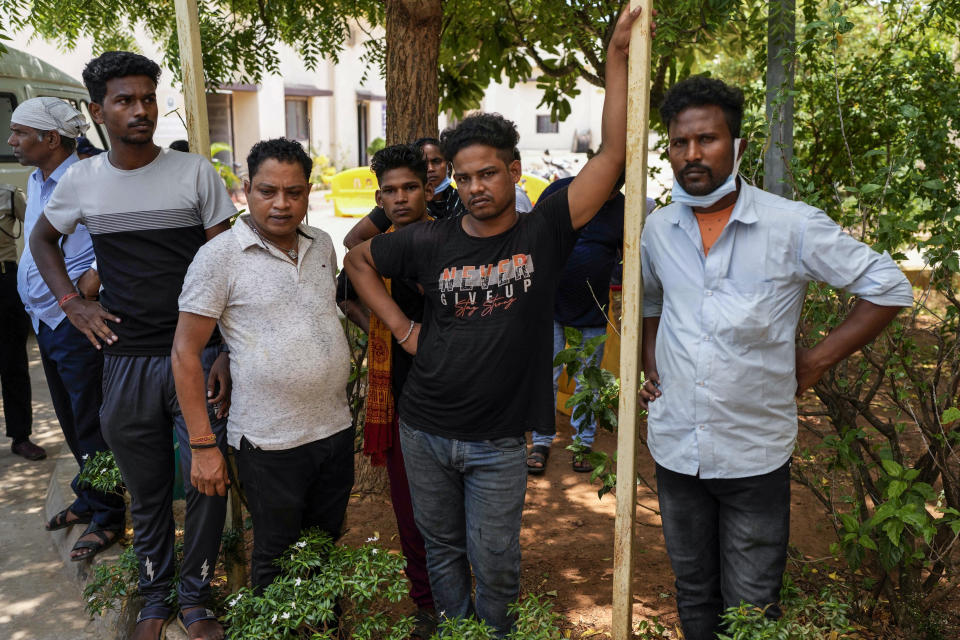 People wait to receive bodies of those who died in Friday's train accident in Balasore, at the All India Institute of Medical Sciences hospital in Bhubaneswar in the eastern state of Orissa, India, Monday, June 5, 2023. Families of the victims of India’s deadliest train crash in decades filled the hospital on Monday to identify and collect bodies of relatives, as railway officials recommended the country’s premier criminal investigating agency to probe the crash that killed 275 people. (AP Photo/Rafiq Maqbool)