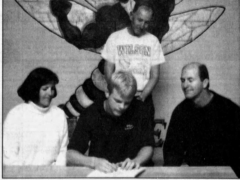 Kyle Walling, center, is being inducted into the Wilson Memorial hall of fame. Here, in a 1999 photo from The News Leader, he is seen signing to play baseball at JMU.