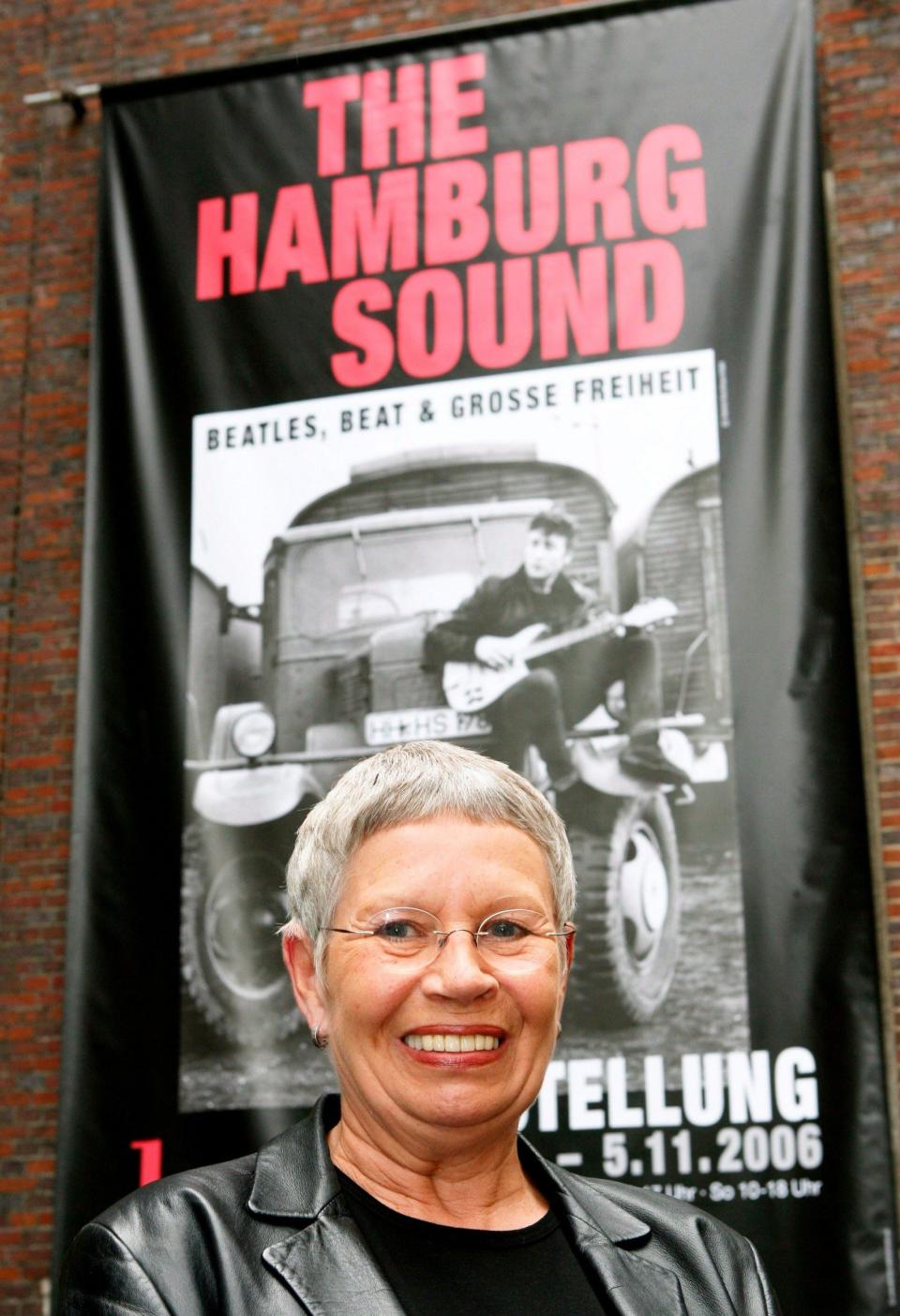 Astrid Kirchherr poses in front of a poster of the exhibition 'The Hamburg Sound' in the Hamburg Museum, in Hamburg, Germany, 01 June 2006 - Maurizio Gambarini/EPA-EFE/Shutterstock