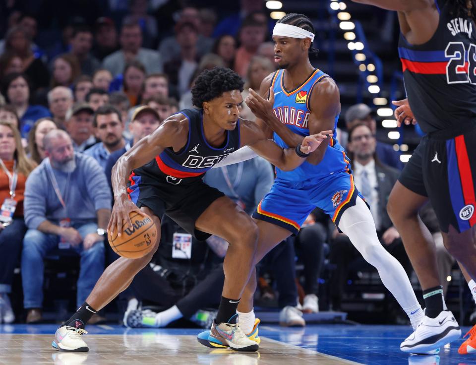 Detroit Pistons forward Ausar Thompson drives against Oklahoma City Thunder guard Shai Gilgeous-Alexander during the second quarter at Paycom Center in Oklahoma City, Okla., Oct. 30, 2023.