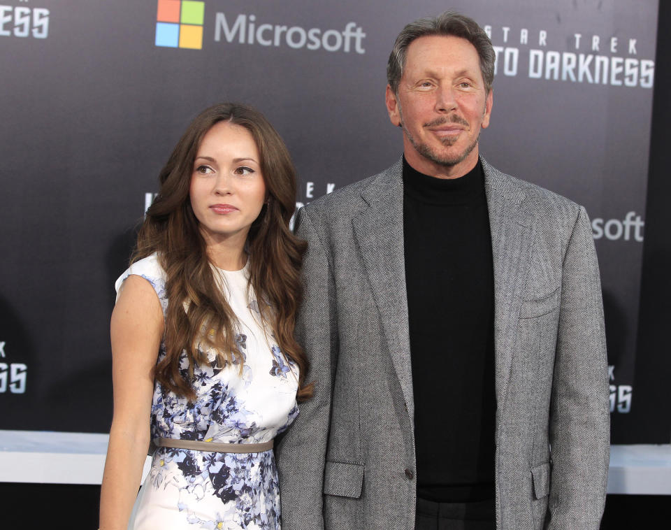 Oracle CEO Larry Ellison and Nikita Kahn pose in front of a wall marked Microsoft, Star Trek Into Darkness.