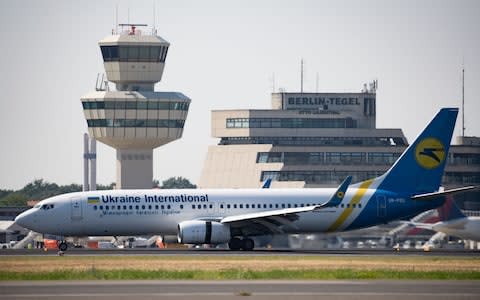 A Ukraine International Airlines Boeing 737-800 airplane taxis in front of the tower  - Credit: REX
