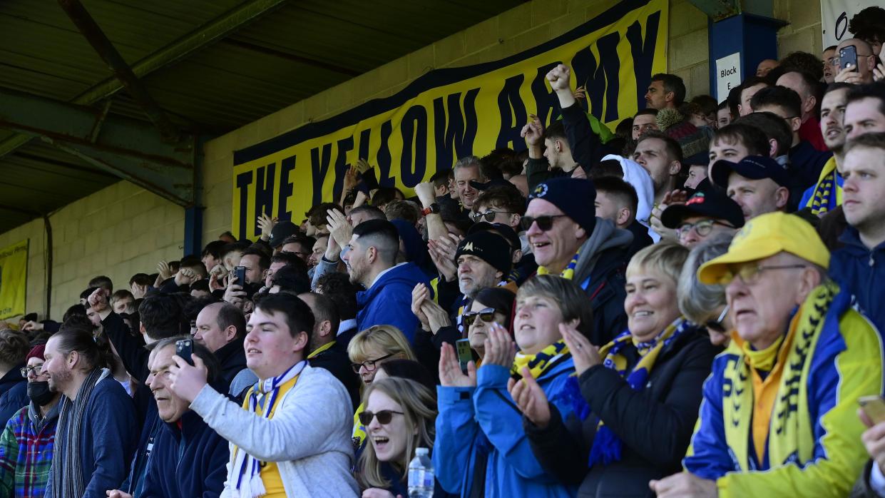 Torquay United supporters cheer on their side