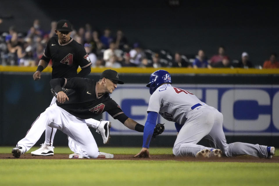 Chicago Cubs' Willson Contreras (40) gets tagged out by Arizona Diamondbacks shortstop Nick Ahmed, left, while trying to steal second base in the third inning during a baseball game, Saturday, July 17, 2021, in Phoenix. (AP Photo/Rick Scuteri)