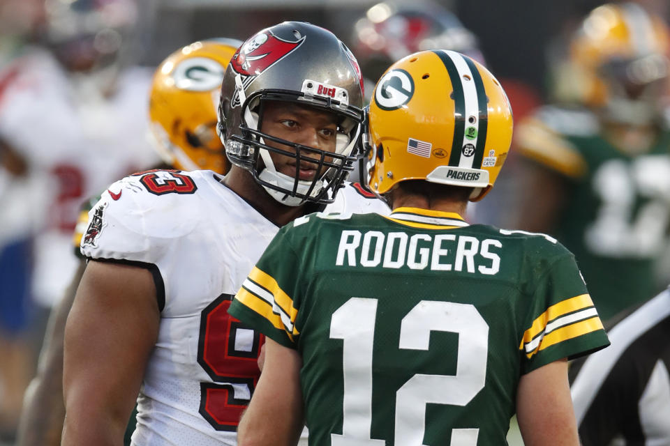 FILE - Tampa Bay Buccaneers defensive end Ndamukong Suh (93) talks with Green Bay Packers quarterback Aaron Rodgers (12) during the second half of an NFL football game in Tampa, Fla., in this Sunday, Oct. 18, 2020, file photo. Rodgers had his worst game of the season in Green Bay’s 38-10 loss at Tampa Bay Back on Oct. 18, as he threw two game-changing interceptions and completed less than half his pass attempts. Rodgers gets a chance to make amends for that performance Sunday when the top-seeded Packers host the Bucs in the NFC championship game. (AP Photo/Jeff Haynes, File)