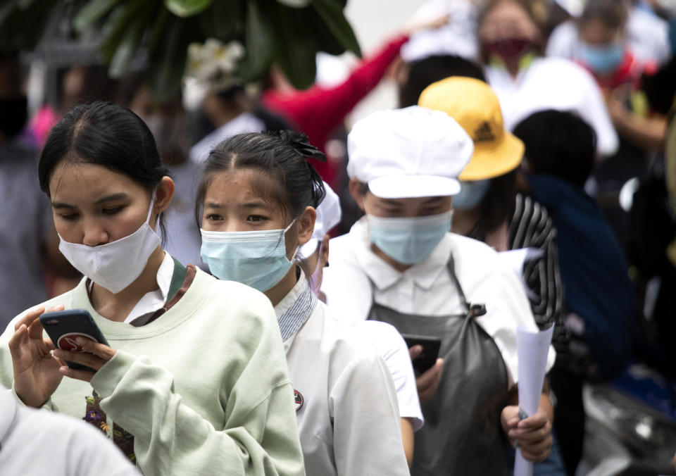 People line up for the coronavirus test in Rayong province, Thailand, Tuesday, July 14, 2020. Authorities set up testing for anyone concerned they might have come into contact with an Egyptian soldier who visited a shopping mall in Rayong last week and then tested positive for COVID-19. In Thailand, where there has been no reports of locally transmitted cases for seven weeks, health authorities were rushing to trace the contacts of two recent foreign arrivals in the country who were infected with the coronavirus and may have violated quarantine rules.(AP Photo/Sakchai Lalit)