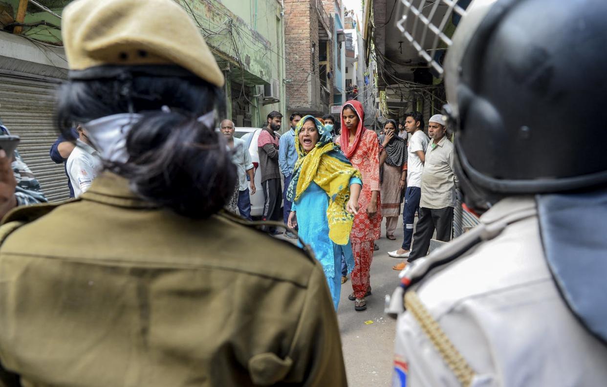 A Muslim protester shouts at security personnel on the streets of Shaheen Bagh, a neighborhood in Delhi, in 2020. <a href="https://www.gettyimages.com/detail/news-photo/muslim-woman-shouts-at-security-personnel-that-patrol-on-news-photo/1208074998?adppopup=true" rel="nofollow noopener" target="_blank" data-ylk="slk:Sajjad Hussain/AFP via Getty Images;elm:context_link;itc:0;sec:content-canvas" class="link ">Sajjad Hussain/AFP via Getty Images</a>