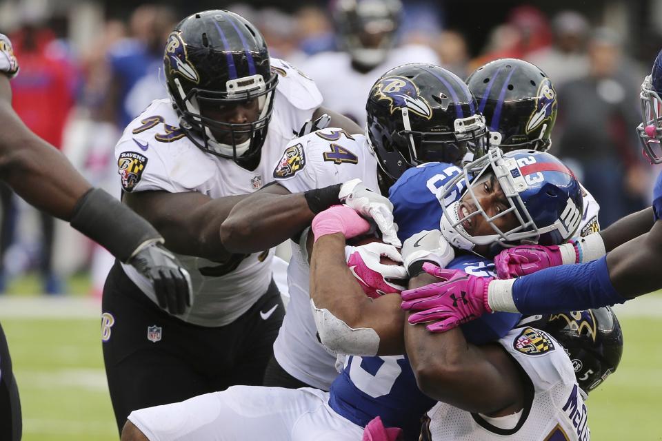 <p>New York Giants’ Rashad Jennings (23) is tackled by Baltimore Ravens’ Timmy Jernigan (99), Zach Orr (54) and Kamalei Correa (51) during the second half of an NFL football game, Sunday, Oct. 16, 2016, in East Rutherford, N.J. (AP Photo/Seth Wenig) </p>