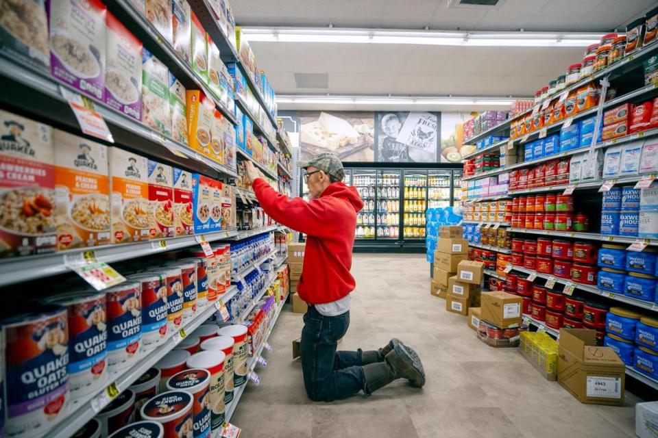 David Sexton, who was worked at Isom IGA for 15 years, stocks product at the grocery store in Isom, Ky., on Thursday, March 30, 2023. The grocery store is scheduled to reopen Saturday, April 1, 2023, after being heavily damaged by flooding eight months ago.