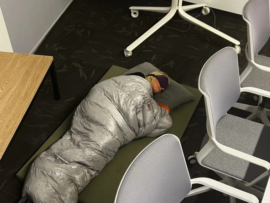 An employee posted a picture on Twitter of Esther Crawford sleeping in the office.