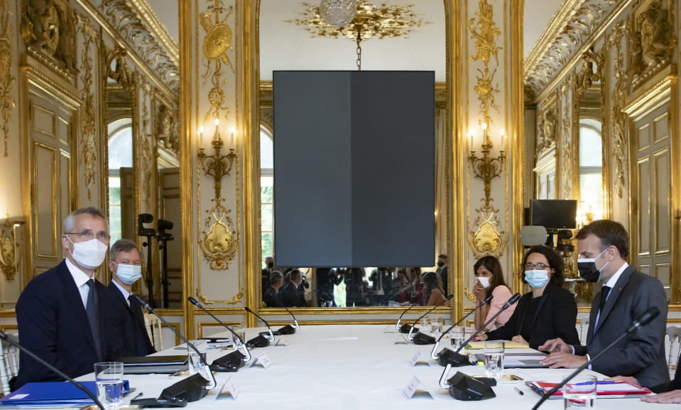 French President Emmanuel Macron, right, holds a meeting with NATO Secretary General Jens Stoltenberg, left, at the Elysee Palace in Paris, France, Friday May 21 2021. (Ian Langsdon, Pool via AP)