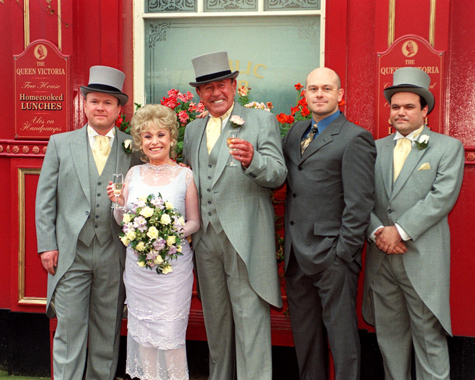 EastEnders stars Barbara Windsor (who plays bride 'Peggy Mitchell') and Mike Reid (groom 'Frank Butcher', third from left), with co-stars during a photocall outside the Queen Vic pub at London's Elstree studios, where their on-screen wedding reception was filmed.   * Joined by fellow actors (l-r) Steve McFadden (Phil), Ross Kemp (Grant), and Shaun Williamson (Barry).   (Photo by John Stillwell - PA Images/PA Images via Getty Images)