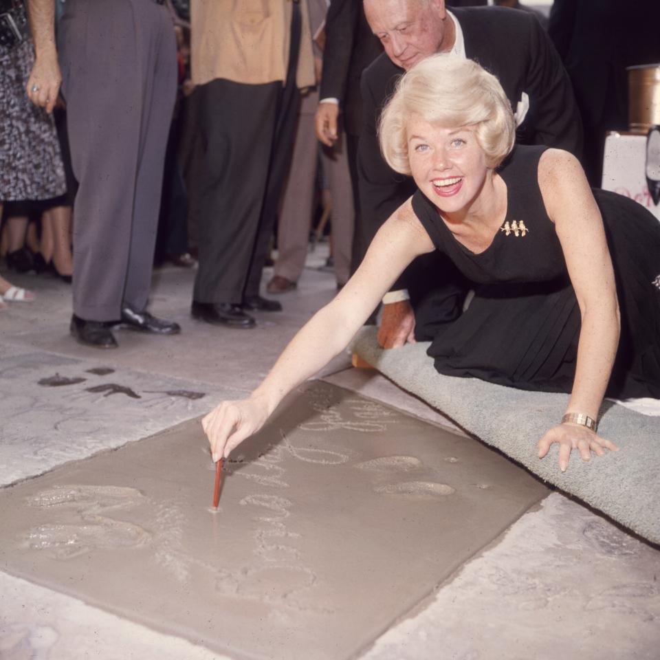 Day signs her name in cement outside Mann's Chinese Theater.