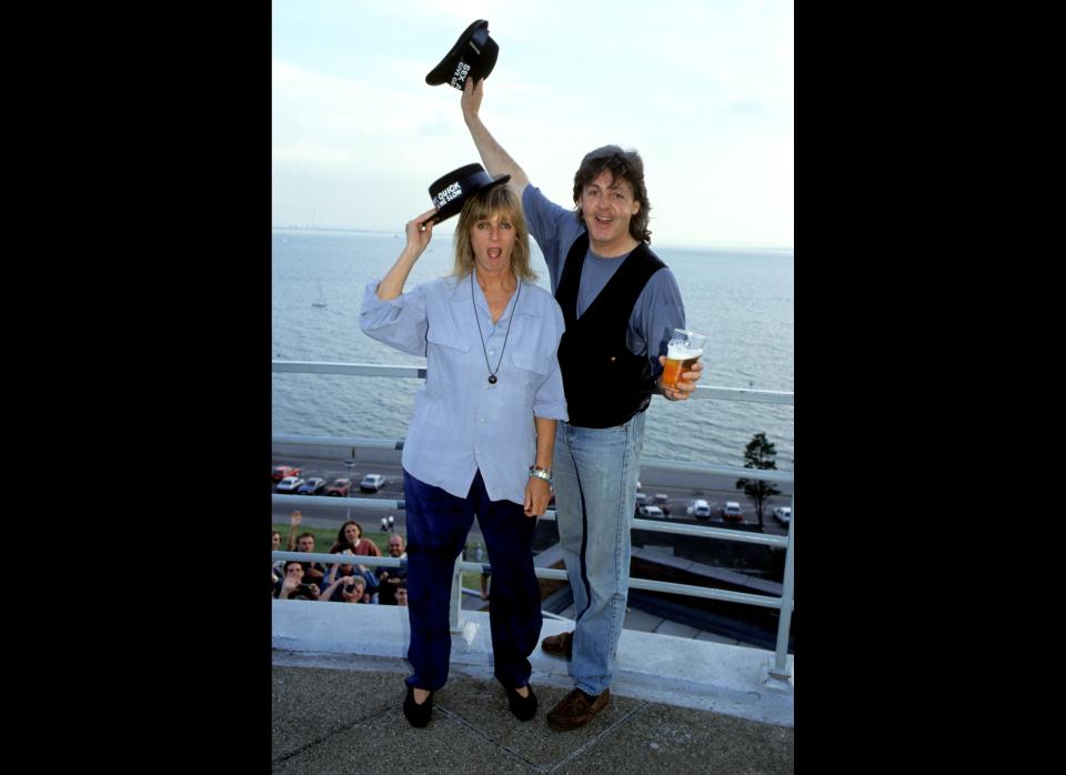 British rock and roll legend Paul McCartney and his wife, Linda McCartney, mess around with 'Kiss Me Quick' hats at the seaside (Circa 1989).