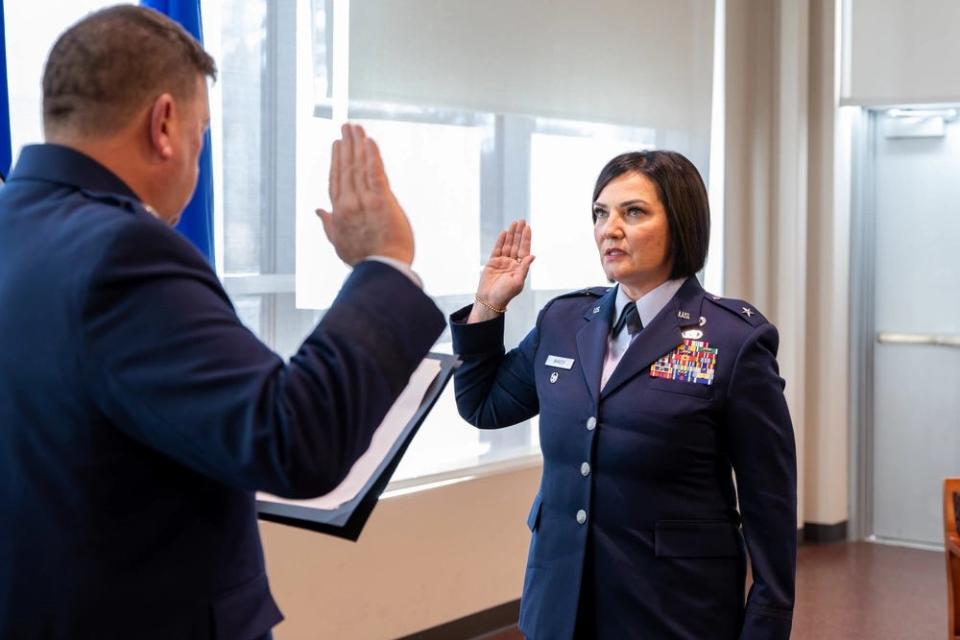 Maj. Gen. Gary Keefe, Adjutant General of the Massachusetts National Guard, issues an oath to Brig. Gen. Lisa Ahaesy during her promotion ceremony at the Massachusetts National Guard Joint Forces Headquarters, Hanscom Air Force Base, on Dec. 12, 2023.
