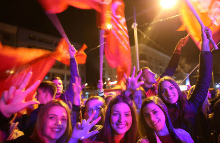 Supporters of the Alliance of Independent Social Democrats (SNSD) celebrate the results of a referendum over a disputed national holiday during an election rally in Pale, Bosnia and Herzegovina, September 25, 2016. REUTERS/Dado Ruvic