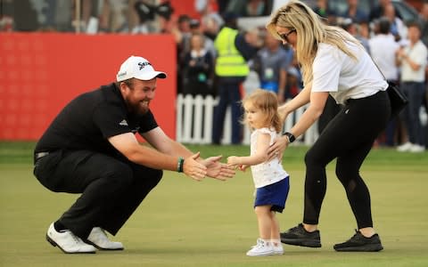 Shane Lowry of Ireland celebrates with wife Wendy Honner and daughter Iris Lowry on the 18th green - Credit: Getty Images