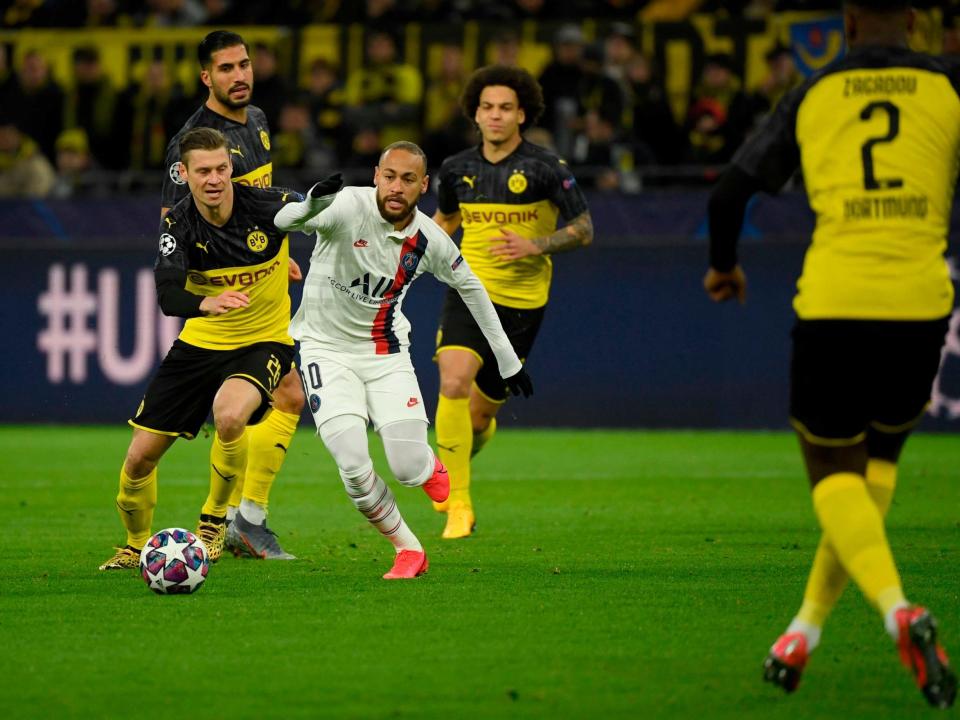 Neymar dribbles at the Dortmund defence: Getty