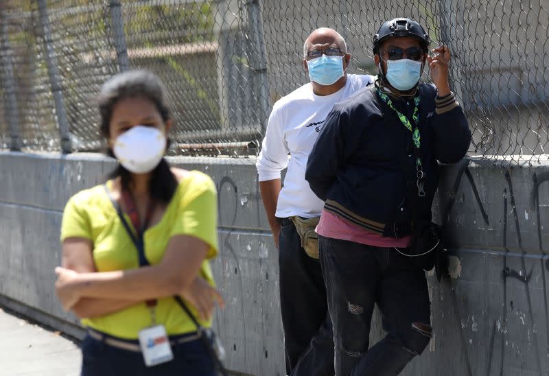 People wearing protective masks on the streets after the start of quarantine in response to the spread of coronavirus disease (COVID-19) in Caracas