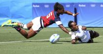 <p>Fiji’s Luisa Basei Tisolo scores on USA’s Akalaini Baravilala. (Reuters) </p>