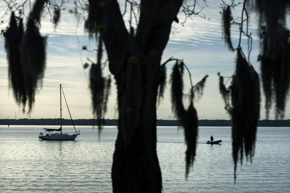 Spanish moss hangs from a tree along the St. Johns River in Palatka, Fla., Thursday, April 15, 2021. After months in a prison cell, Warren Williams longed to fish the St. Johns again. He looked forward to spending days outdoors in his landscaping job, and to writing poems and music in his free time. (AP Photo/David Goldman)