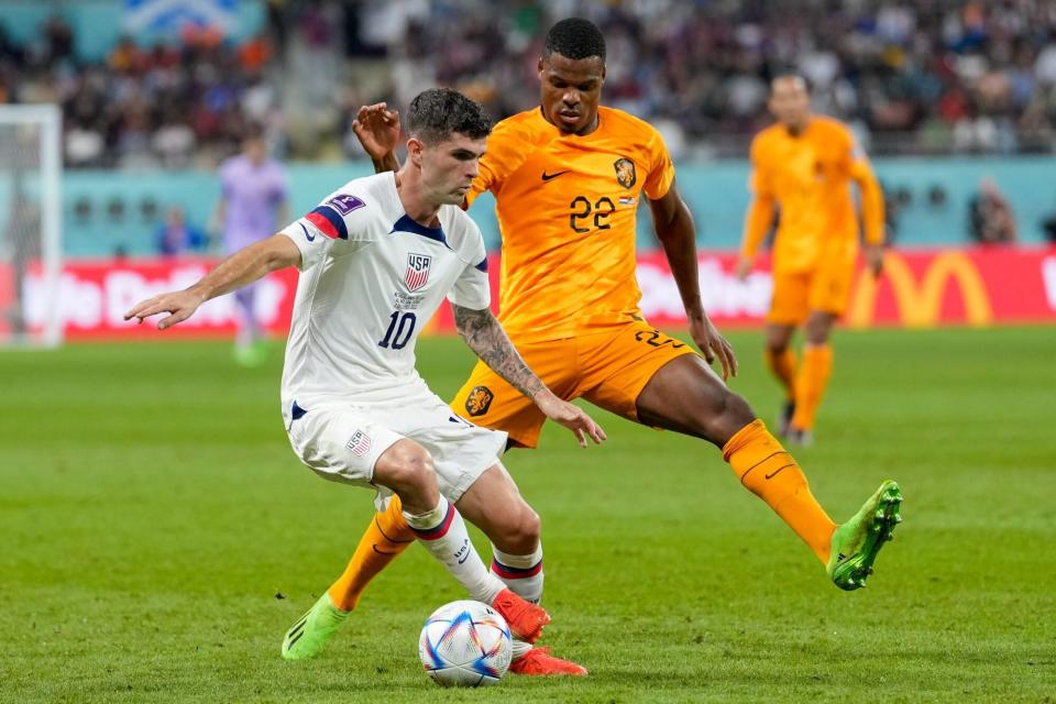 DOHA, QATAR - DECEMBER 03: Christian Pulisic of USA and Denzel Dumfries of Netherlands battle for the ball during the FIFA World Cup Qatar 2022 Round of 16 match between Netherlands and USA at Khalifa International Stadium on December 3, 2022 in Doha, Qatar. (Photo by Mohammad Karamali/DeFodi Images via Getty Images)