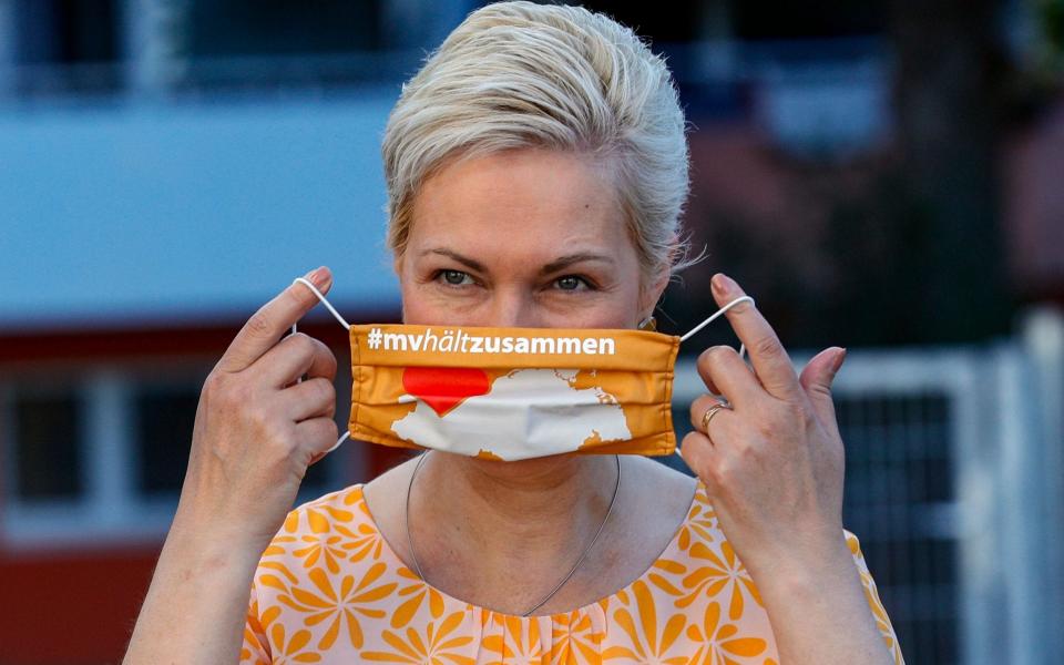 Mandatory Credit: Photo by FELIPE TRUEBA/EPA-EFE/Shutterstock (10729924d) Prime Minister of the German federal state of Mecklenburg-Western Pomerania, Manuela Schwesig, puts on a sanitary mask as she arrives at the Lankow elementary school enrolment ceremony in Schwerin, Germany, 01 August 2020. Thousands of children of Mecklenburg-Western Pomerania celebrated their first day in school with classes resuming on 03 August. This federal state is the first in Germany to officially open the new school year complying with health protocols imposed by the coronavirus pandemic. Children have to wear mask in the common areas of the school buildings. First day in school for pupils of Mecklenburg-Western Pomerania, Schwerin, Germany - 01 Aug 2020 - FELIPE TRUEBA/EPA-EFE/Shutterstock