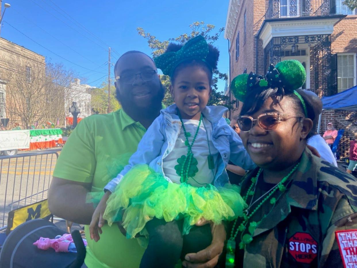 Cedric Brown and Tiffany Brown with their 5-year-old daughter in Calhoun Square during the 2022 Savannah St. Patrick's Day Parade.