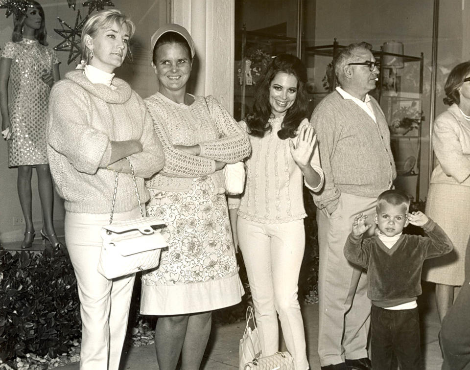 Mrs. Jerome Earl, from left, Mrs. Herbert "Lilly" Pulitzer, Mrs. Mary Alice Firestone and son Mark singing Christmas Carols on Worth Avenue in this undated photo.