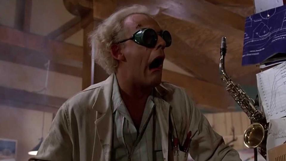 A scientist (Doc Brown from Back to the Future), with white hair and goggles, gasp